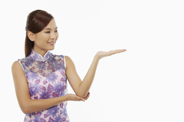 Woman in traditional clothing showing hand gesture