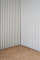 Empty interior scene of rattan display on gray corrugated background concept. Blank product shelf standing backdrop.