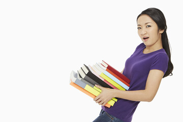Woman carrying a stack of books