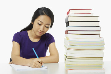 Woman writing notes in book