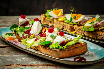 Assorted bruschetta with various toppings. Appetizing bruschetta or crudo crostini. set for wine. Variety of small sandwiches