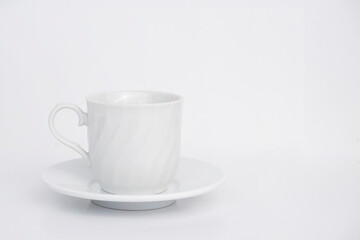 Vintage white ceramic coffee cup and saucer on white background