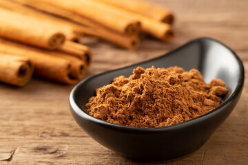 Close up cinnamon powder in a bowl background