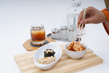 Chinese Dim sum in a bamboo steamer with white background