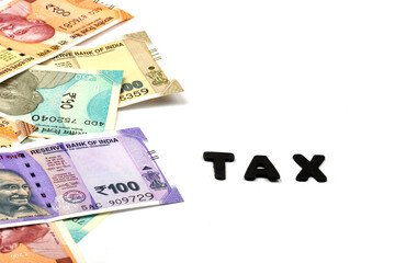 TAX concept,TAX alphabet on money background,business and financial concept idea,Indian Currency, Rupee, Indian Rupee,Indian Money, Business, finance, investment, saving and corruption  - Image