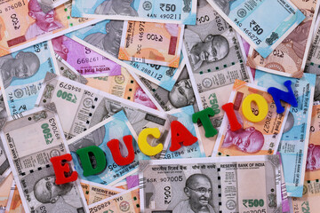 Education concept,Education alphabet on money background,Indian Currency, Rupee, Indian Rupee,Indian Money, Business, finance, investment, saving and corruption concept - Image