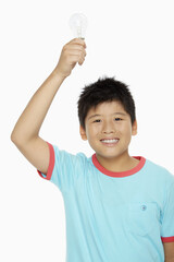 Boy holding up a light bulb