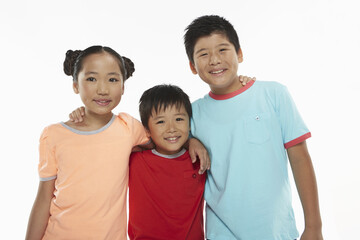 Three children with arms around smiling at the camera