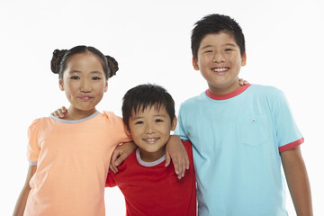 Three children with arms around smiling at the camera