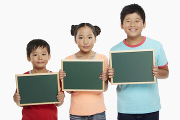 Children holding up a blackboard