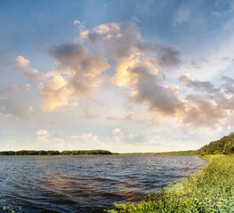 Fototapeta na wymiar Panoramic view of lake shore and beautiful sky on summer day