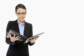 Businesswoman reading notes from a folder