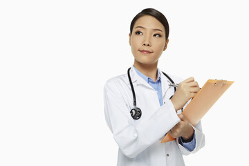 Medical personnel writing notes on a clipboard