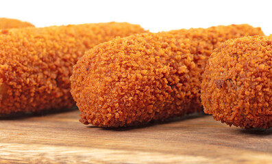 Brown crusty dutch kroketten on a serving tray, selective focus
