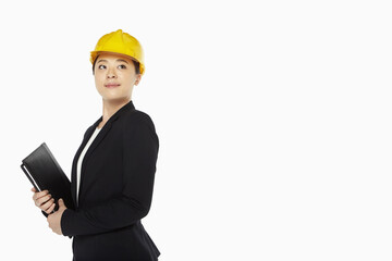 Female architect smiling and holding a folder