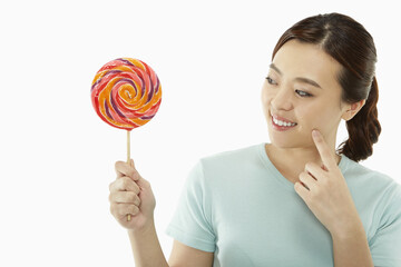Happy woman with a colorful lollipop