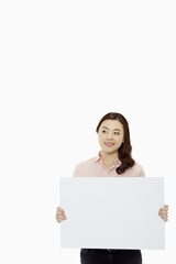 Woman holding up a blank placard