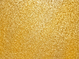 Defocusing. Golden textured shiny background with glitter. Holidays and birthdays. Space for text.