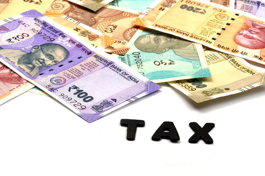 TAX concept,TAX alphabet on money background,business and financial concept idea,Indian Currency, Rupee, Indian Rupee,Indian Money, Business, finance, investment, saving and corruption  - Image