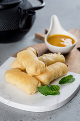 Fried sweet sticks with jam on the board