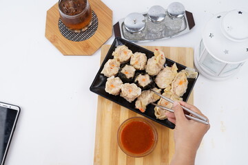 Chinese Dim sum in a bamboo steamer with white background