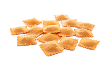 Fresh ravioli pasta colored with paprika isolated on a white background