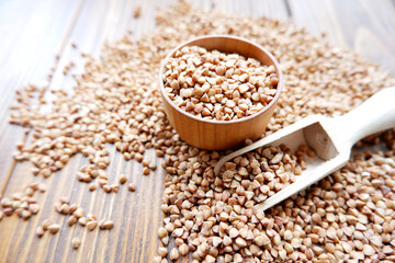 Buckwheat in a wooden plate on the table. Porridge, natural food