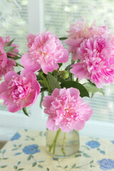 Pink peonies in vase on the table. country still life