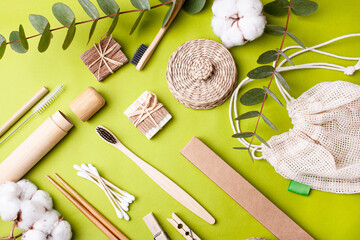 Zero waste. Wooden items on a green background. Knife, fork, toothbrushes, clothespin, bamboo stick, natural soap. Flat Lay Style