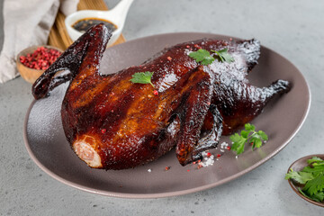 Cooked whole duck in the oven on a plate