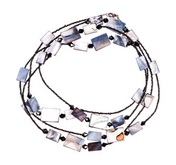 top view of handcrafted necklace from black glass beads and polished pieces of mother-of-pearl...
