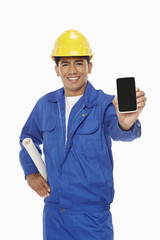 Construction worker holding up a mobile phone