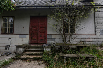 Fototapeta na wymiar entrance with stairs and a red door from a old house