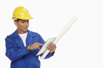Construction worker using a digital tablet