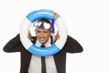 Businessman with swimming gear looking through a swimming tube