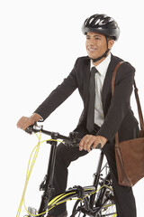Naklejka premium Businessman riding a bicycle