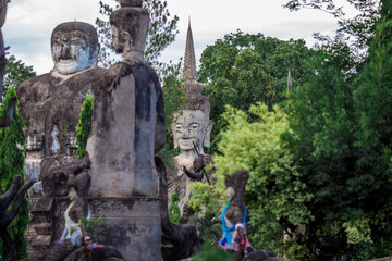 Fototapeta na wymiar Sala Keoku-Nongkhai:June19,2020,the atmosphere inside the religious tourist site,there is a garden and a corridor around a large sculpture,tourists come to see the beauty of the holiday,Thailand