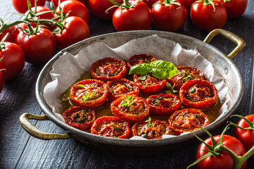 Roasted tomatoes with olive oil thyme oregano and basil in pan