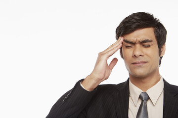 Businessman touching his forehead