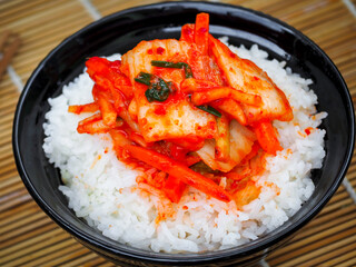 Korean food, top view kimchi with a rice in bowl tasty yummy and spicy on wood table background for healthy. 