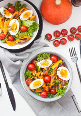 Vegetable salad with grilled carrot, cherry tomatoes, pumpkin, lettuce, boiled eggs and sesame seeds.