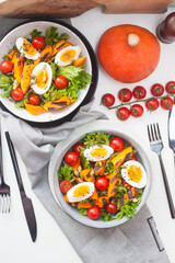 Vegetable salad with grilled carrot, cherry tomatoes, pumpkin, lettuce, boiled eggs and sesame seeds.