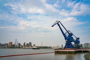 Fototapeta na wymiar A vintage crane in expo park along the Huangpu river in Shanghai, shot a cloudy day.