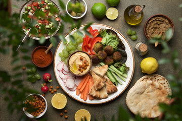 Festive dinner table with hummus plate and appetizers. Meze party food. Top view, flat lay