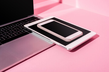 modern gadgets with blank screens on pink background