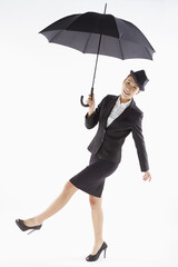Cheerful businesswoman posing with an umbrella