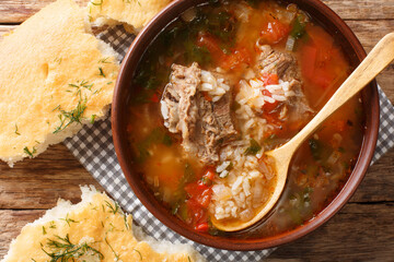 Kharcho soup with beef, rice with spices and vegetables, served with Georgian bread close-up. horizontal top view