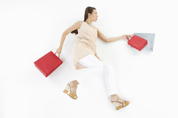 Woman posing on the floor with shopping bags