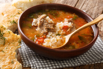 Kharcho soup with beef, rice with spices and vegetables, served with Georgian bread close-up on the table. horizontal