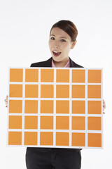 Businesswoman holding up a board of adhesive notes